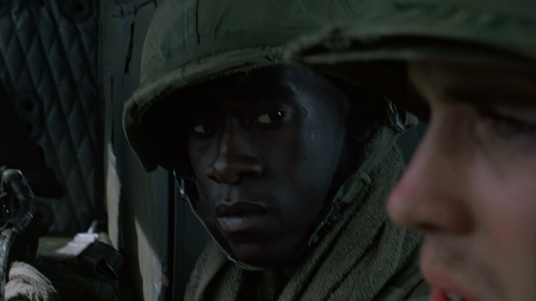 Don Cheadle's Johnny Washburn looks across at a fellow soldier as he sits in a helicopter in Hamburger Hill