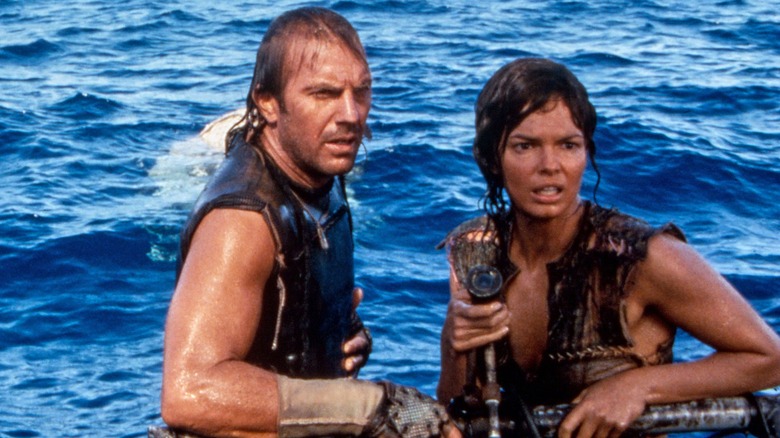 Kevin Costner wet in ocean with Jeanne Tripplehorn