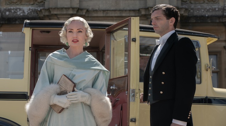 Laura Haddock and Michael Fox standing outside Downton in Downton Abbey: A New Era
