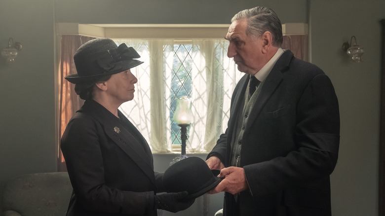 Phyllis Logan and Jim Carter dressed for a funeral in Downton Abbey: A New Era
