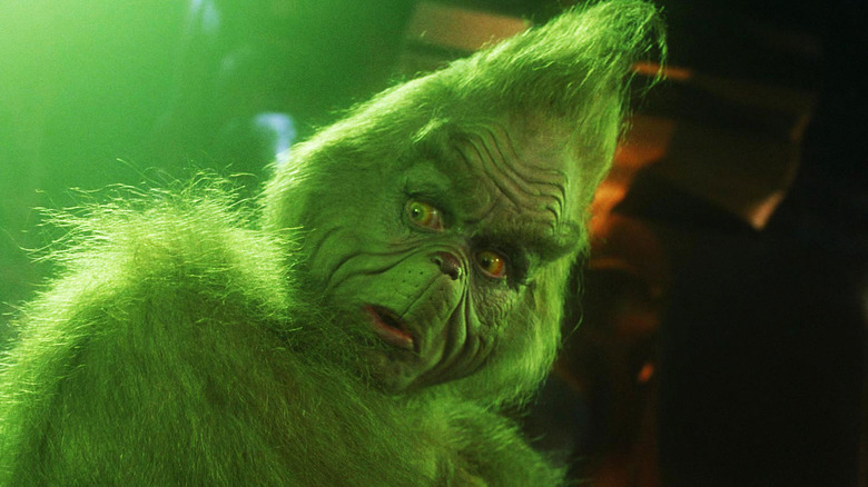 Jim Carrey's Grinch looks shocked as he stares down in How the Grinch Stole Christmas