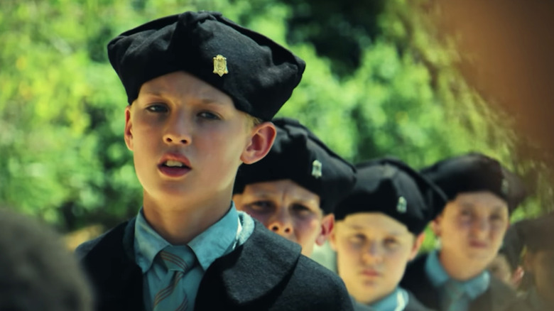 Lox Pratt's Jack stands in front of other choristers on a beach in Lord of the Flies