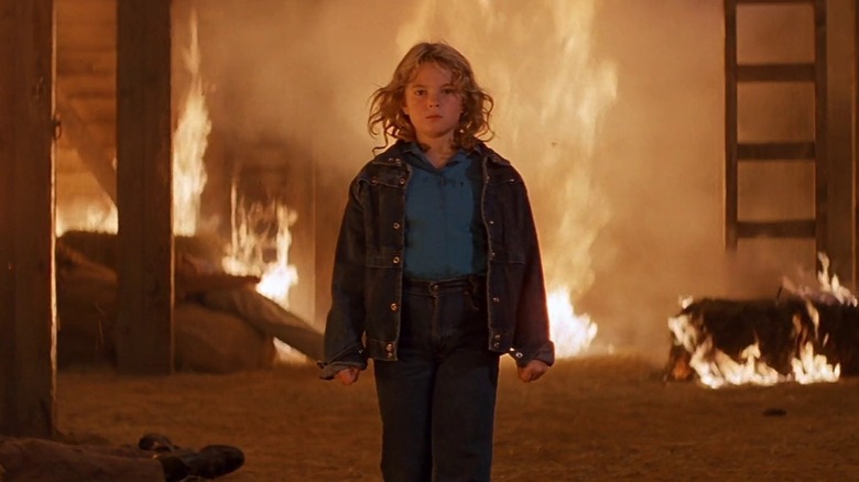 Drew Barrymore as Charlie McGee, walking away from a fire she started, in Firestarter (1984)