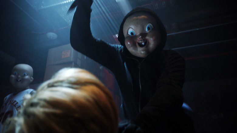 The masked killer getting ready to stab Tree in Happy Death Day 2U