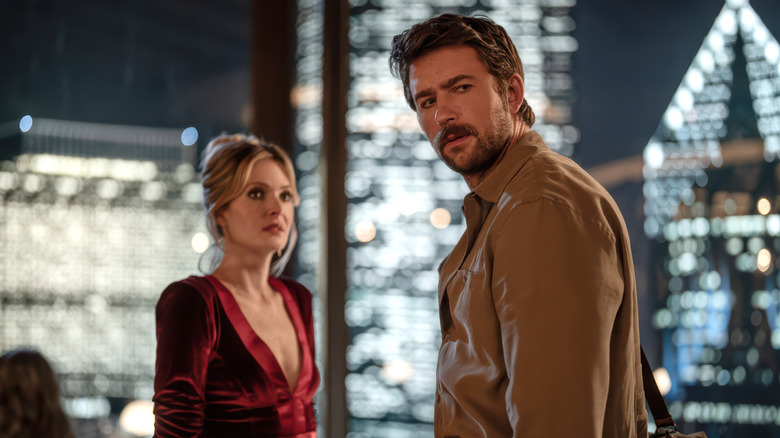 Meghann Fahy's Violet and Brandon Sklenar's Henry standing in the restaruant in Drop