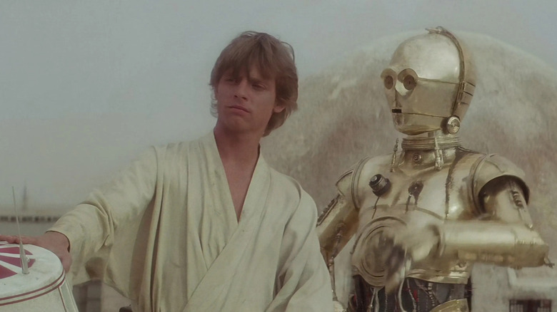 Luke Skywalker and C3P-O in the desert in Star Wars