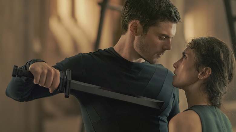 Chris Mason as Keiran Atreides and Sarah-Sofie Boussnina as Princess Ynez spar with swords in Dune: Prophecy