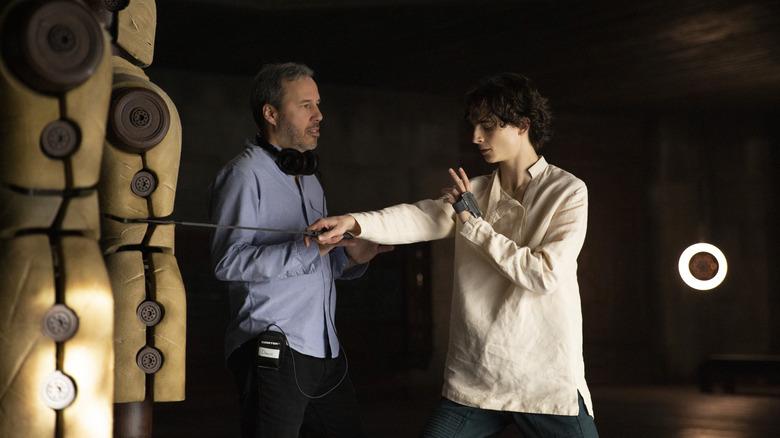 Caption: (L-r) Director/co-writer/producer DENIS VILLENEUVE and TIMOTHÉE CHALAMET on the set of Warner Bros. Pictures' and Legendary Pictures' action adventure "DUNE," a Warner Bros. Pictures and Legendary release.