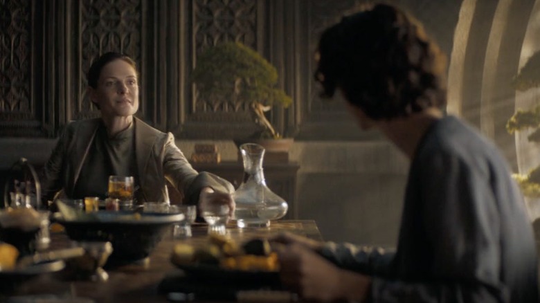 Rebecca Ferguson as Lady Jessica eats at a dinner table with Timothée Chalamet as Paul Atreides in Dune: Part One