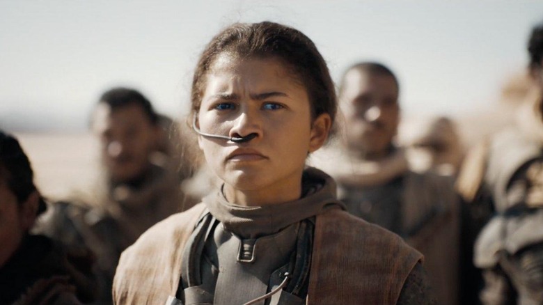 Zendaya as Chani with a concerned look on her face in the desert in Dune: Part Two