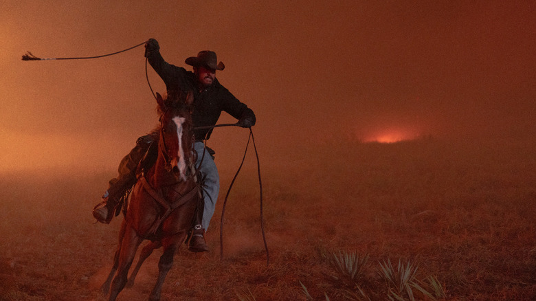 Cole Hauser's Rip Wheeler rides his horse through a fiery landscape in Dutton Ranch