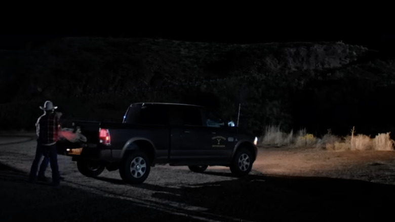 A truck parked next to a cliff known as the Train Station on Yellowstone