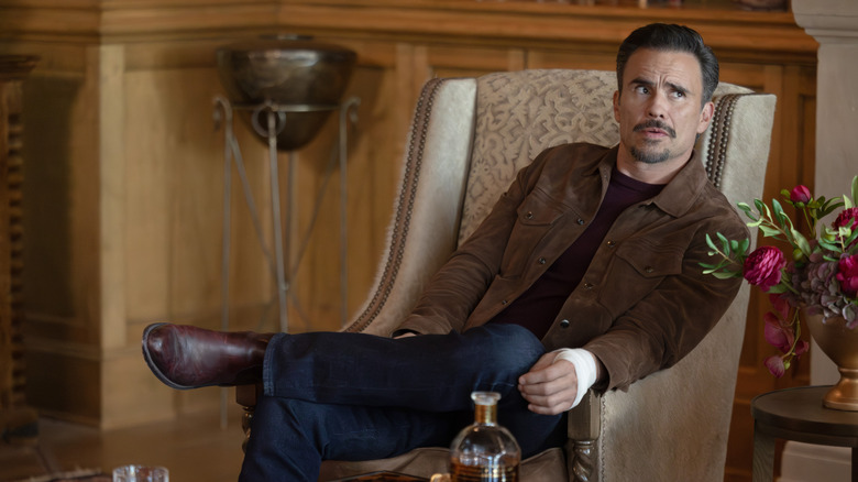 Juan Pablo Raba's Joaquin Reyes sits in a chair in Dutton Ranch.jpg