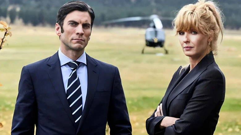Wes Bentley's Jamie Dutton stands beside Kelly Reilly's Beth Dutton in a field with a helicopter in the background in Yellowstone