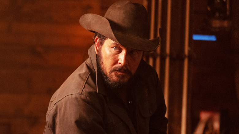 Cole Hauser's Rip Wheeler looks off to his right as he sits in a cabin in Dutton Ranch