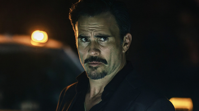 Juan Pablo Raba's Joaquin Reyes stands in front of a truck at night in Dutton Ranch