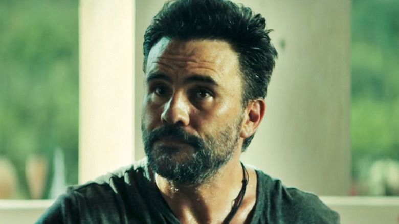 Juan Pablo Raba's Guapo sits looking off to his right in Long Gone Heroes