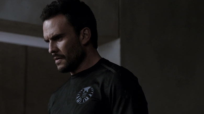 Juan Pablo Raba's Joey Gutierrez looks serious in closeup as he stands in a dim room in Agents of S.H.I.E.L.D
