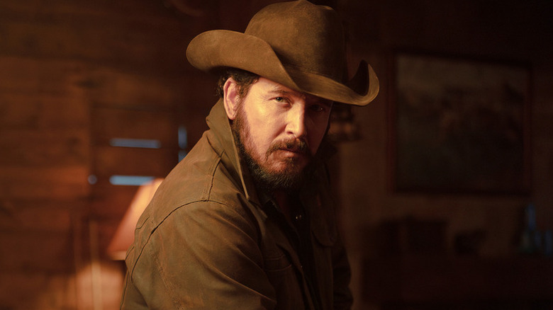 Rip Wheeler (Cole Hauser) sitting in a dimly-lit room on "Dutton Ranch."
