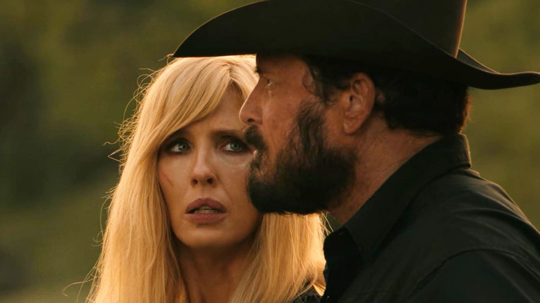 Cole Hauser's Rip Wheeler looks off into the distance next to Kelly Reilly's Beth Dutton, who appears worried, in Dutton Ranch