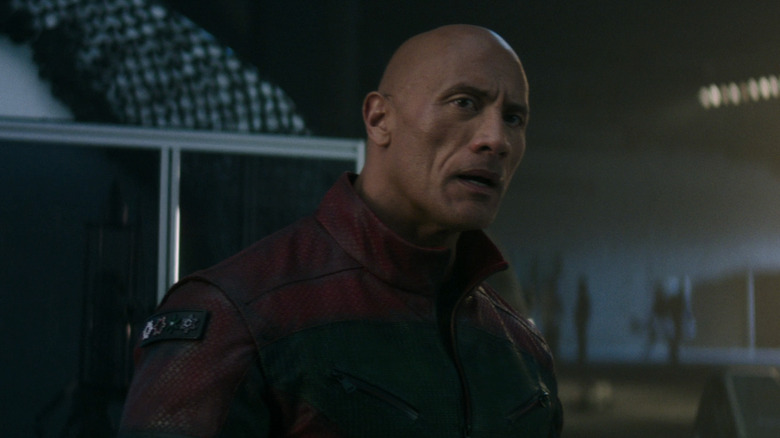 Dwayne Johnson's Callum Drift looks worried as he stands in a warehouse in Red One