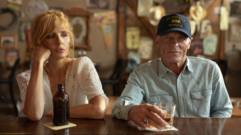 Kelly Reilly's Beth Dutton sits next to Ed Harris' Everett McKinney at a bar in Dutton Ranch