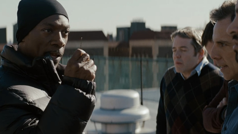 Eddie Murphy as Darnell Davis holds up a bobby pin as he talks to Matthew Broderick as Mr. Fitzhugh, Casey Affleck as Charlie Gibbs, and Ben Stiller as Josh Kovaks in Tower Heist