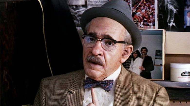 Eddie Murphy hangs out in a barbershop as Saul in Coming to America