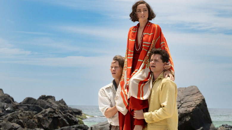 Ana de Armas as Baroness Eloise Bosquet de Wagner Wehrhorn carried on the shoulders of Felix Kammerer as Rudolph Lorenz and Toby Wallace as Robert Phillipson in Eden