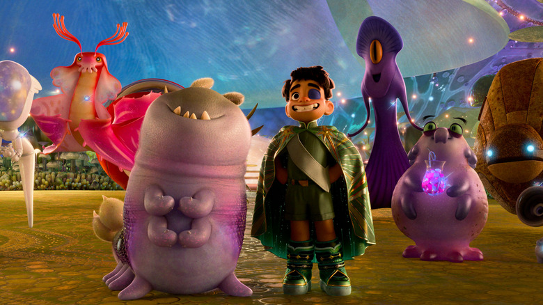 Yonas Kibreab as the voice of Elio standing beside aliens Glordon (Remy Edgerly), Tegman (Matthias Schweighöfer), Helix (Brandon Moon), Turais (Ana de la Reguera), and Questa (Jameela Jamil) in Elio