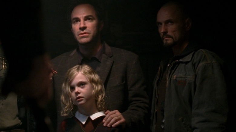 Howard holding Anna with a shadowy dude next to them in  The Lost Room