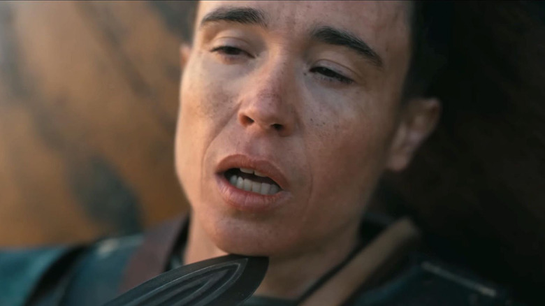 Elliot Page as Sinon with a sword against his neck in The Odyssey (2026)