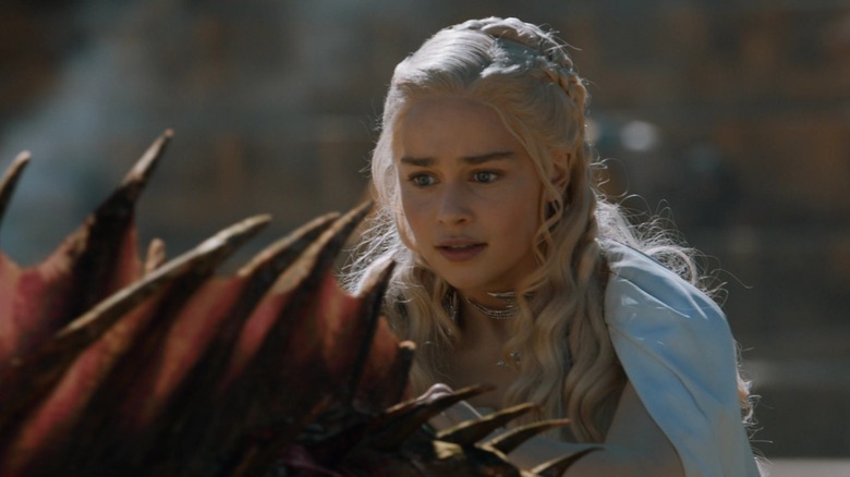Emilia Clarke as Daenerys Targaryen riding a dragon in Game of Thrones