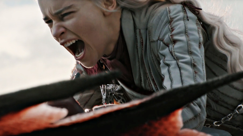Emilia Clarke as Daenerys Targaryen yelling as she rides a dragon in Game of Thrones