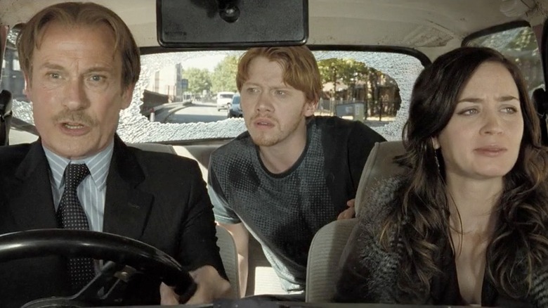 Bill Nighy's Victor Maynard driving a car with Rupert Grint's Tony and Emily Blunt's Rose as passengers in Wild Target