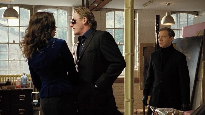 Rupert Everett's Ferguson intimidating Emily Blunt's Rose as Martin Freeman's Hector Dixon watches in Wild Target