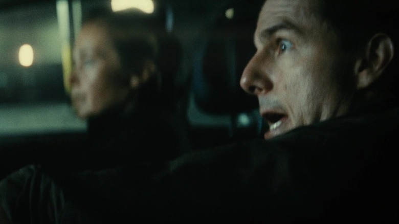 Tom Cruise as William Cage panicking while Emily Blunt as Rita Vrataski drives their car in Edge of Tomorrow