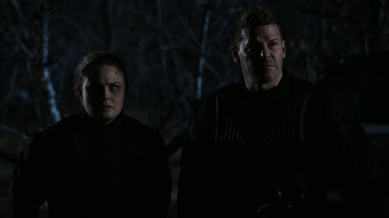 David Boreanaz's Seeley Booth stands in the dark alongside Emily Deschanel's Temperance Brennan in Bones
