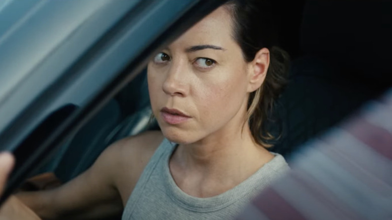 Emily the Criminal Plaza in a car