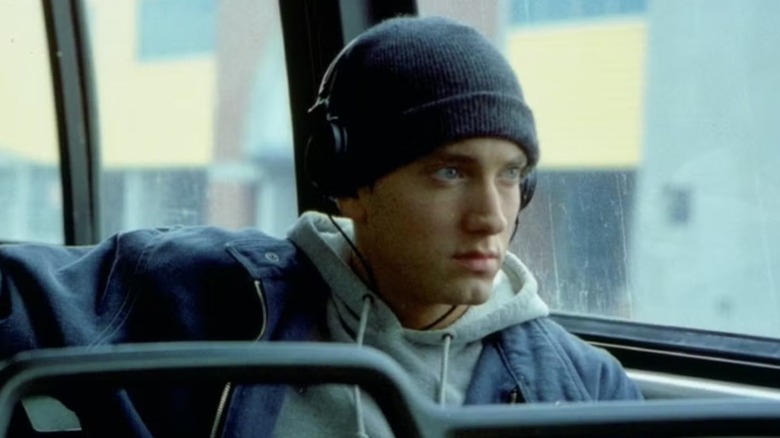 B Rabbit sat on a bus over the window with headphones