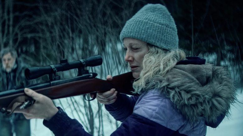 Judy Greer as the Purple Lady aims a rifle in Dead of Winter