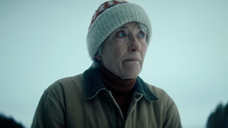 Emma Thompson as Barb looking up while dressed for colder temperatures in Dead of Winter