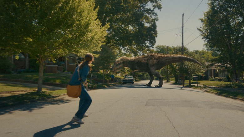 Anne Hathaway as Denise Platt running away from an Allosaur in The End of Oak Street