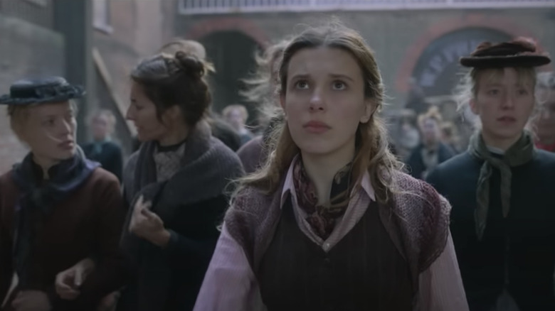 Millie Bobby Brown Enola Holmes 2 outside factory workers