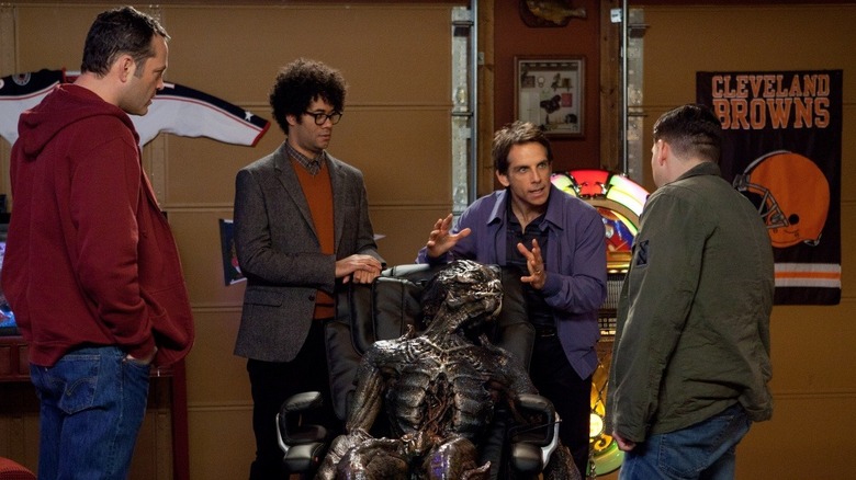 Vince Vaughn as Bob, Richard Ayoade as Jamarcus, Ben Stiller as Evan, and Jonah Hill as Franklin standing around the alien in the garage in The Watch