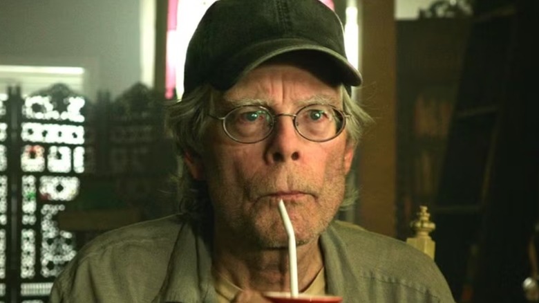 Stephen King drinking from a straw