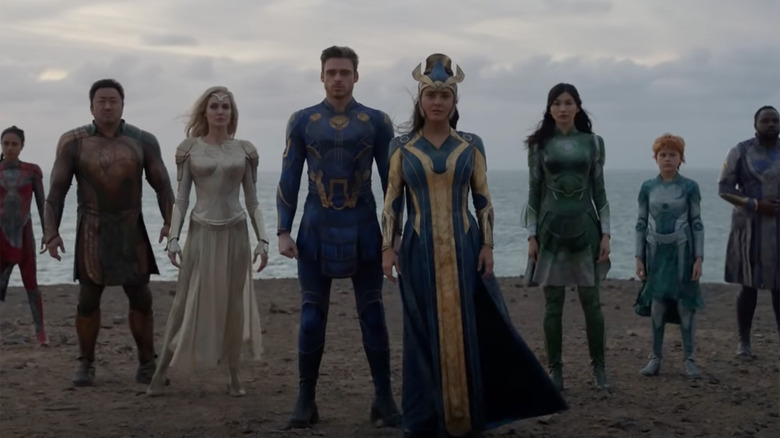 Eternals standing in front of the ocean