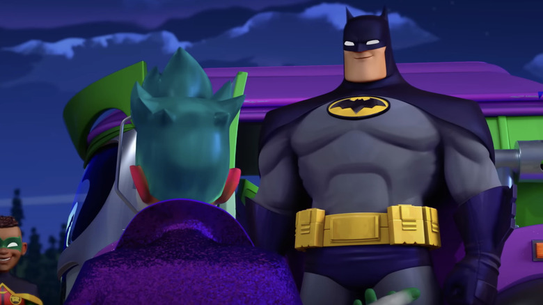 Batman standing in front of the Joker in Batwheels