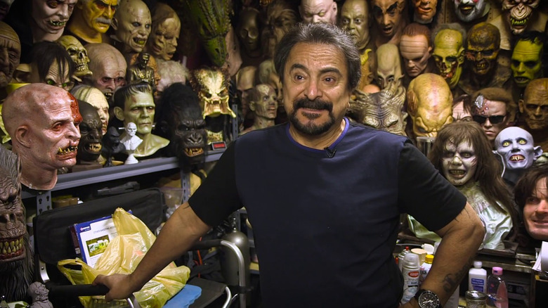 Tom Savini stands among his creations in Smoke & Mirrors: The Story of Tom Savini