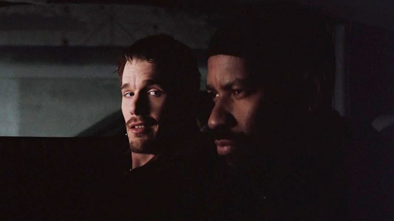 Ethan Hawke's Jake Hoyt looks across at Denzel Washington's Alonzo Harris as they sit in a car in Training Day